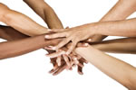 Several persons' hands together, one on top of another