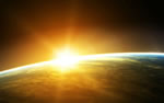 The sun begins to rise radiantly from the far side of the earth as seen from someone in orbit around the earth